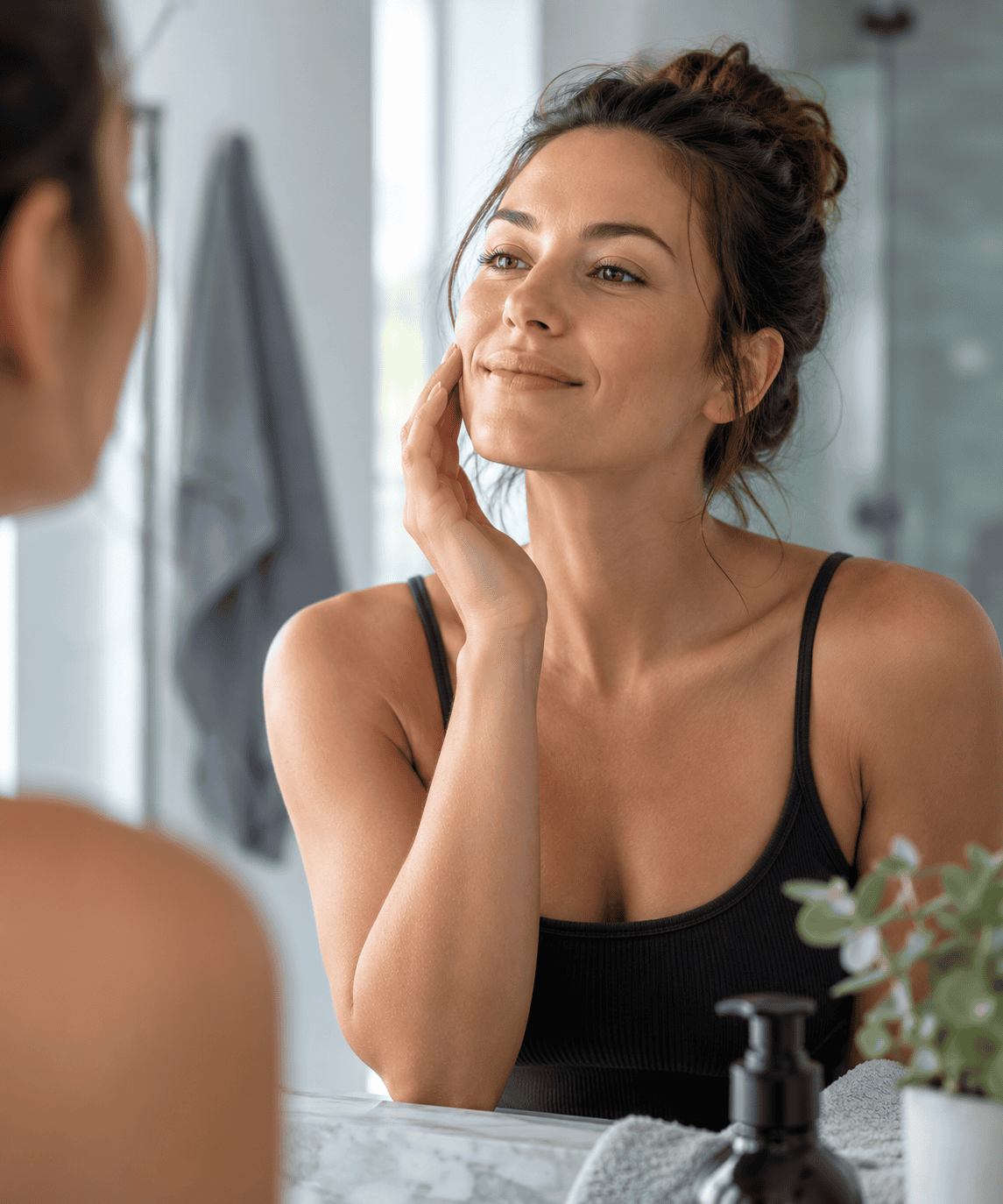 Woman examining her skin in a mirror, representing interest in skin appearance and GHK-Cu